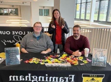 3 staff members sitting at a table